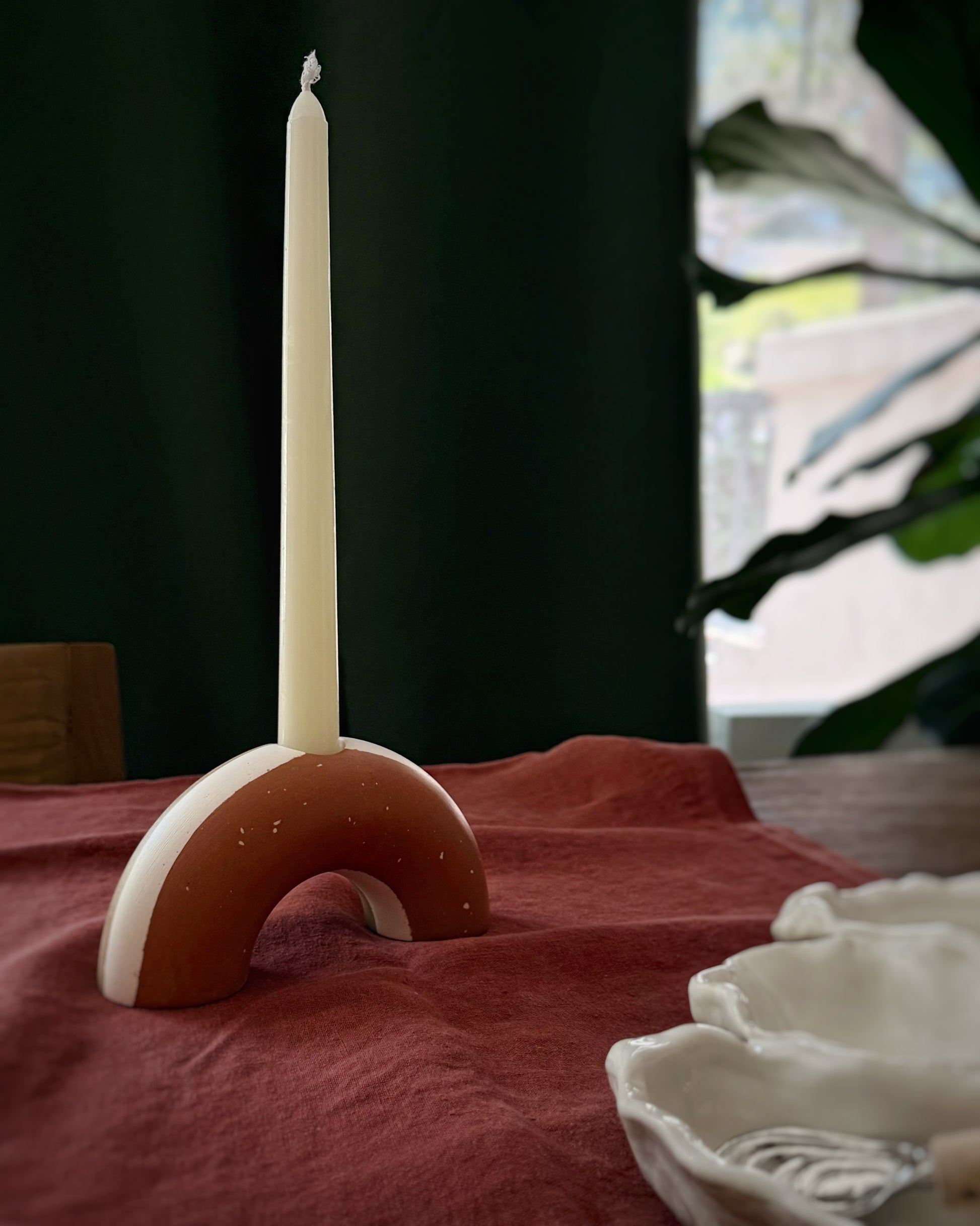 Candle holder with a candle on a red  linen table runner, Fine Dining 4 Home decor for table styling