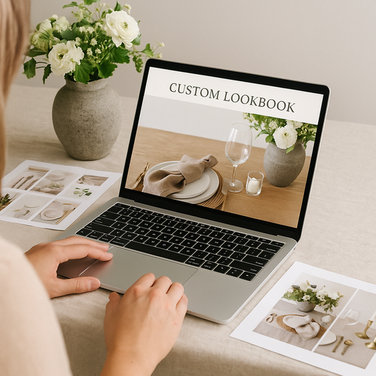 Custom table styling lookbook displayed on laptop screen in a cozy, well-lit home setting.
