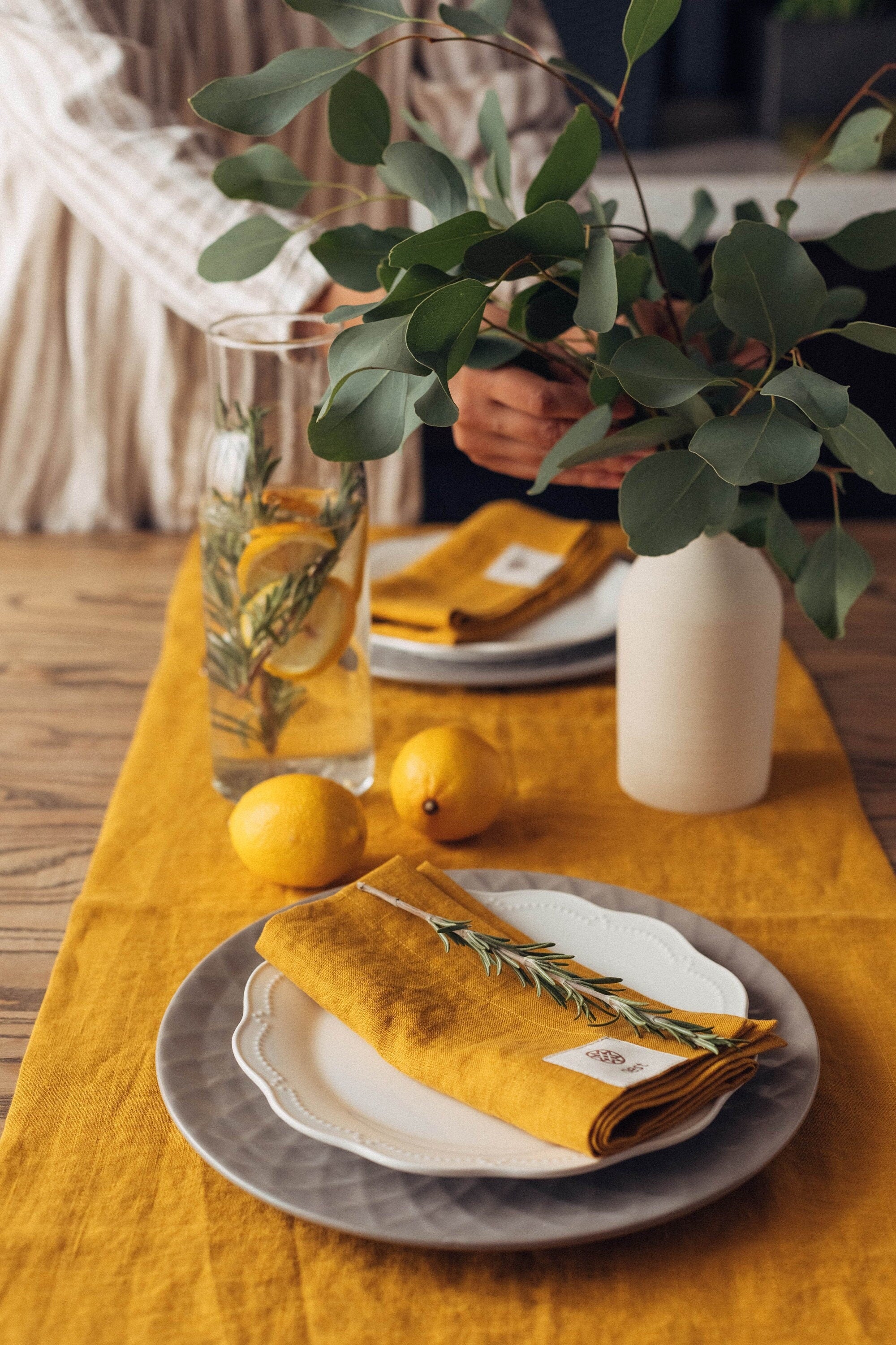 Elegant table setting for summer by Fine Dining 4 Home, styled by Iryna Kolosvetova, linen set in honey color with lemons and rosemary
