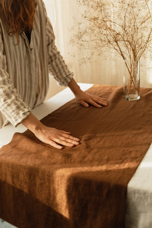 Rustic table setting with linen table runner in brown color